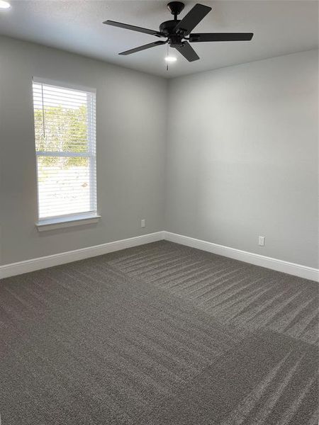 Carpeted 2nd bedroom with ceiling fan