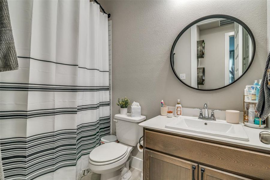 Bathroom with walk in shower, vanity, and toilet