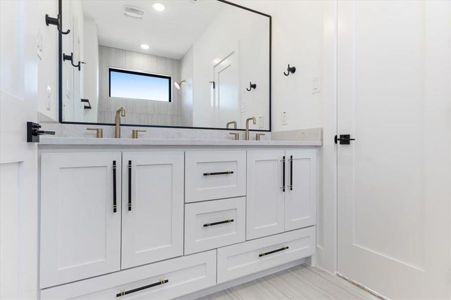 Bathroom featuring dual bowl vanity