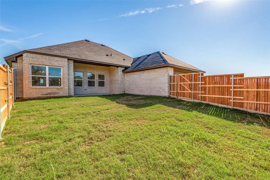 Rear view of house with a yard