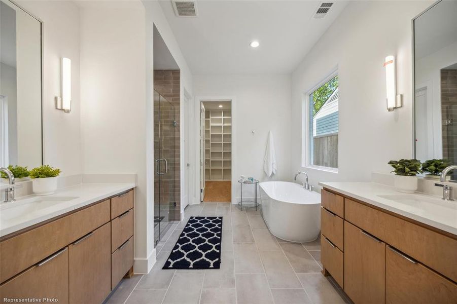 Primary bathroom with soaking tub, standing shower and separate vanities on 1st level