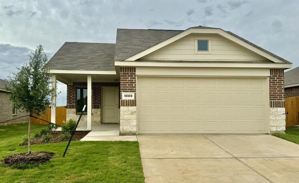 View of front of property with a front lawn and a garage