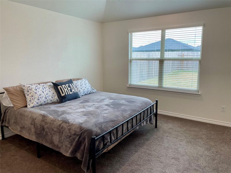 Primary bedroom has a large window.