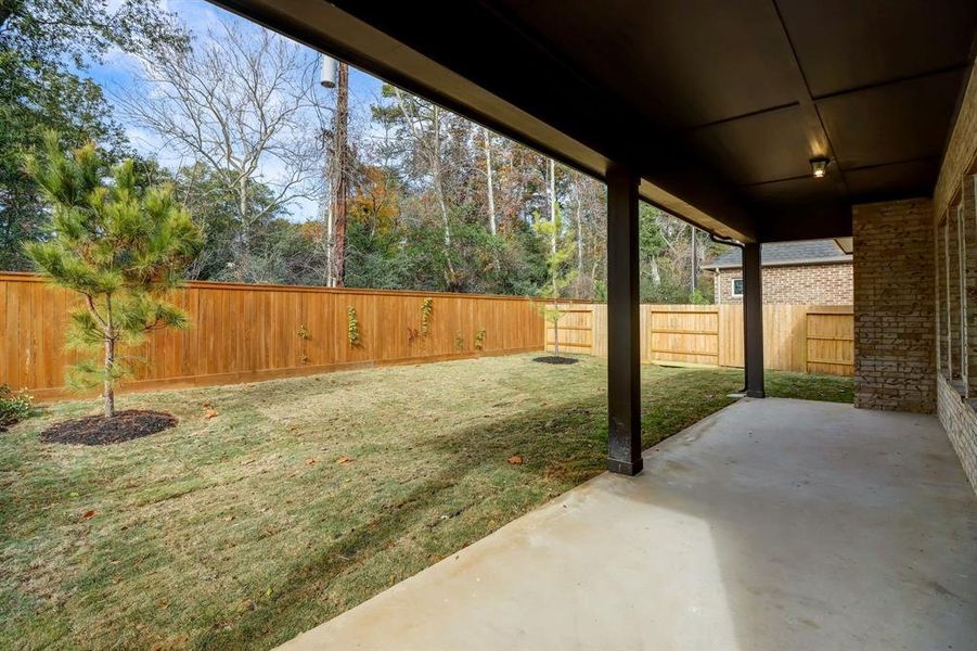 EXAMPLE PHOTO: HUGE covered rear patio overlooks fully sodded lawn with sprinklers
