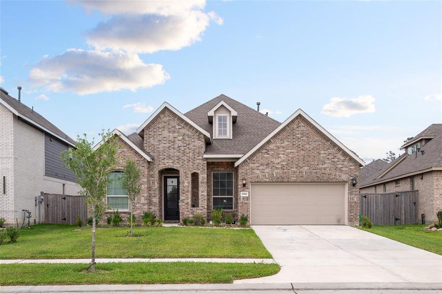 Stunning curb appeal with a beautifully landscaped front yard and an inviting entrance.