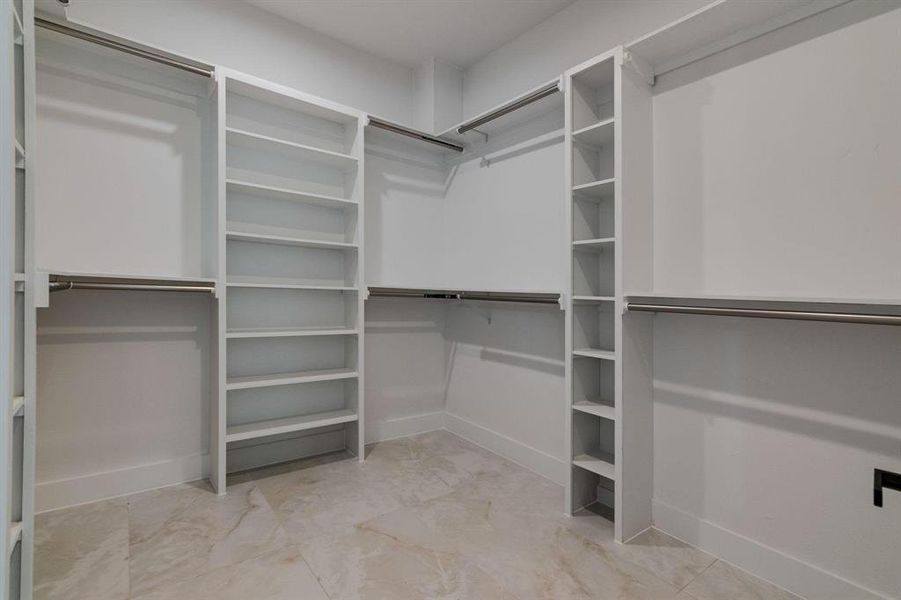 Walk in closet with light tile patterned floors