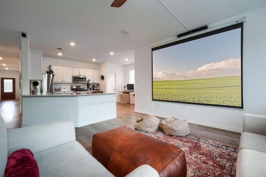 Living room with light wood-type flooring and ceiling fan