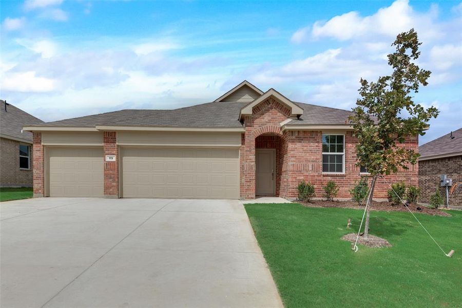 Single story home featuring a garage and a front lawn