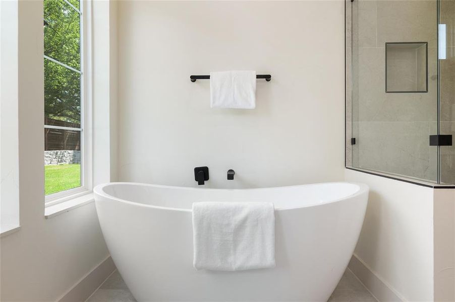 Bathroom featuring tile patterned flooring and a bathtub