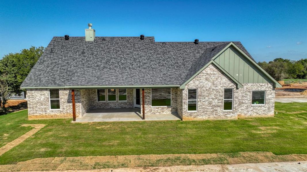 View of front of property featuring a patio and a front lawn