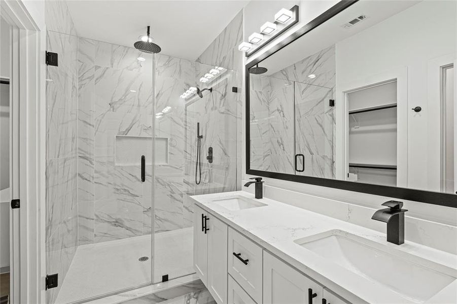 Bathroom featuring vanity and an enclosed shower