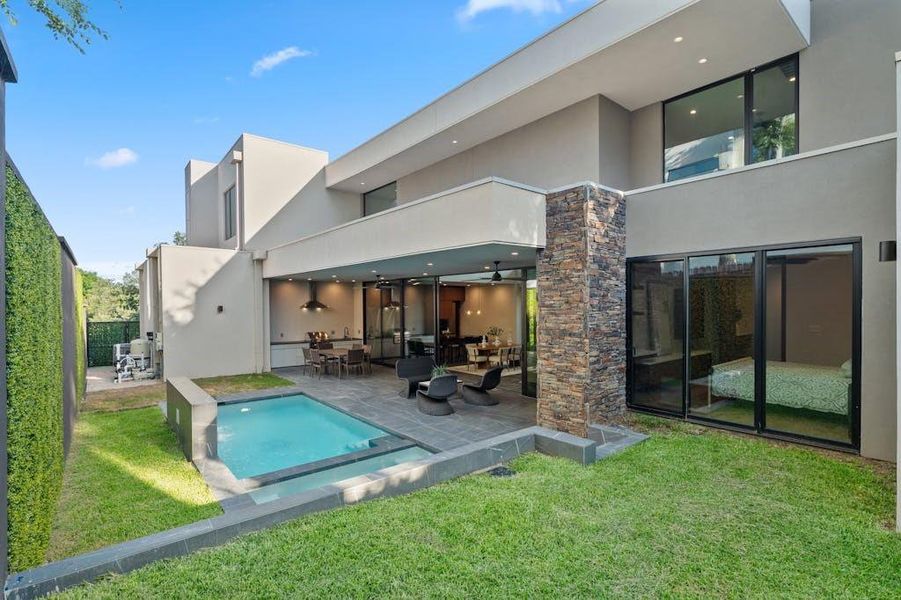 The backyard is a private oasis designed for ultimate relaxation and entertainment. It features a sparkling pool, perfect for cooling off on hot days, and an elegant outdoor kitchen equipped with top-of-the-line appliances, ideal for alfresco dining.