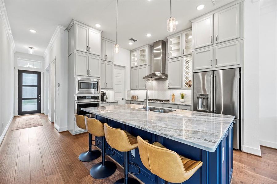 Chef's Kitchen! Cobalt Island Cabinetry and Stunning Light Grey Main Cabinets all the way to the ceiling. Breakfast Bar, Exotic Granite, Stainless Appliances, Coffee Bar, Walk in Pantry, Glass Accent Cabinets, Gas Cooktop, Pot Drawers, Wine Storage, Pull out Trash Cabinet- nThis Kitchen has it All