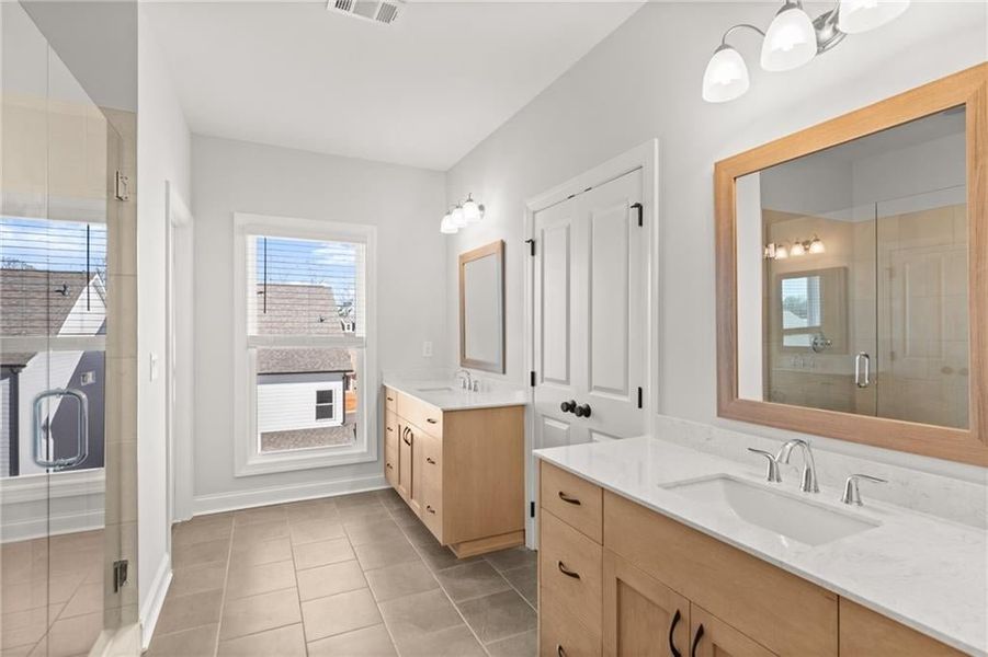 A large tile walk in shower has elegant finishes. NOT actual home. Photos of previously built Grayton floorplan.