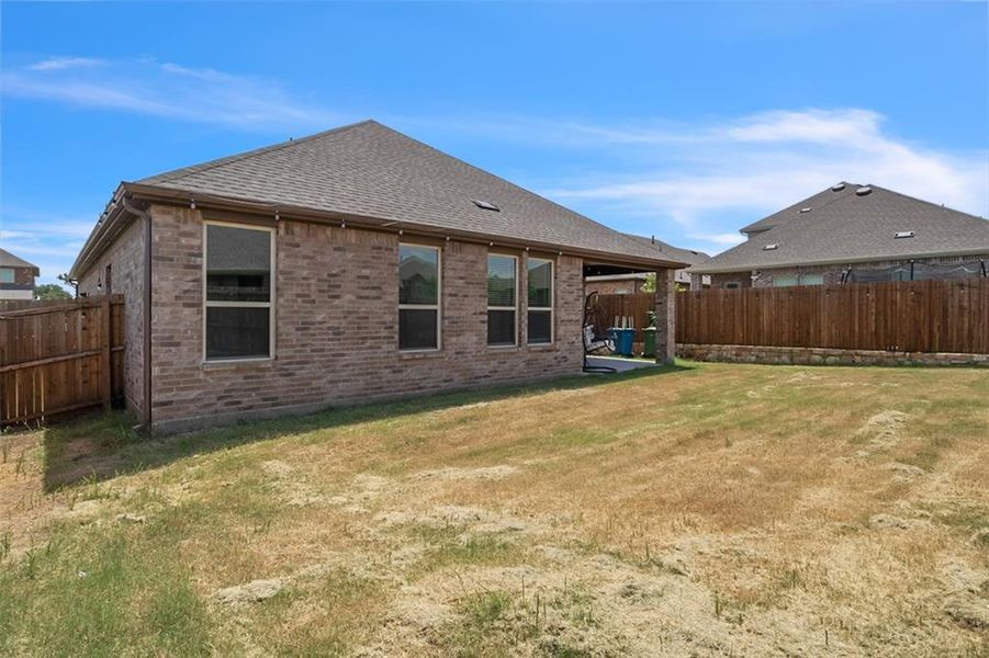 Rear view of property featuring a lawn