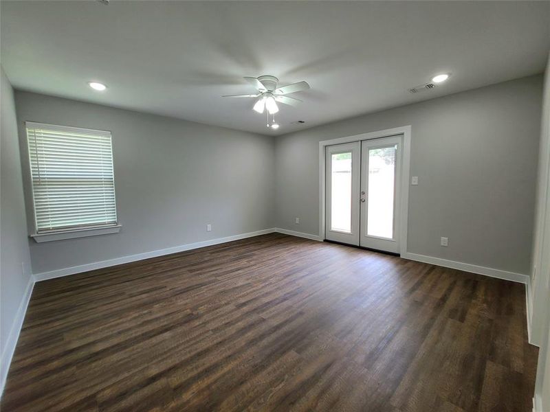 Primary room featuring french doors, ceiling fan, and dark hardwood / wood-style flooring