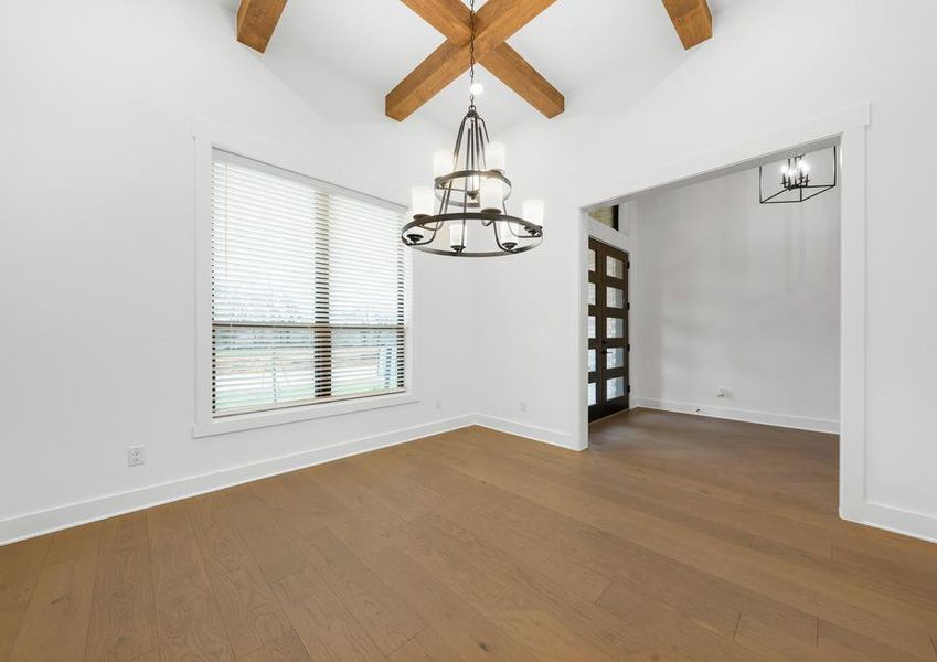 The formal dining room sits right off of the kitchen and has a large window.