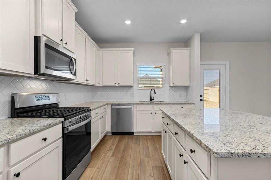 This kitchen is LOADED with upgrades! Whirlpool kitchen appliances and granite countertops gives this space a fresh, modern feel.