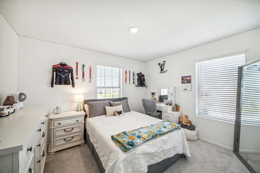 Bright and inviting, this upstairs bedroom provides a peaceful atmosphere and generous closet storage.