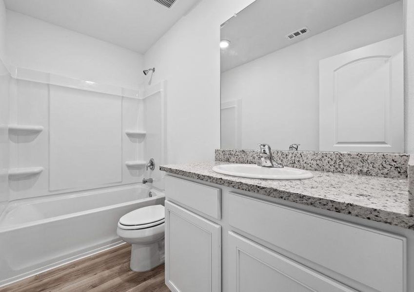 The secondary bathroom features a shower/tub combination