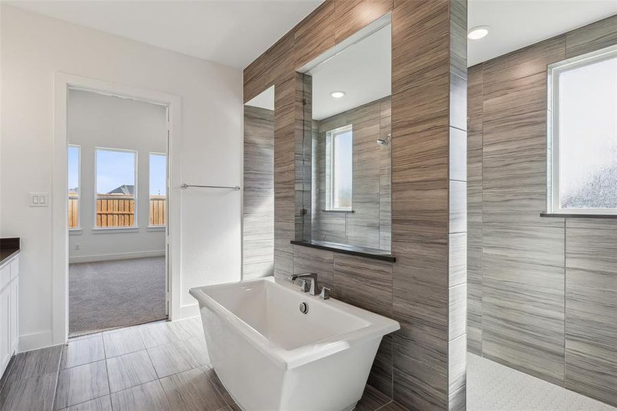 This fantastic owner's bath features our signature freestanding tub with walk through shower!
