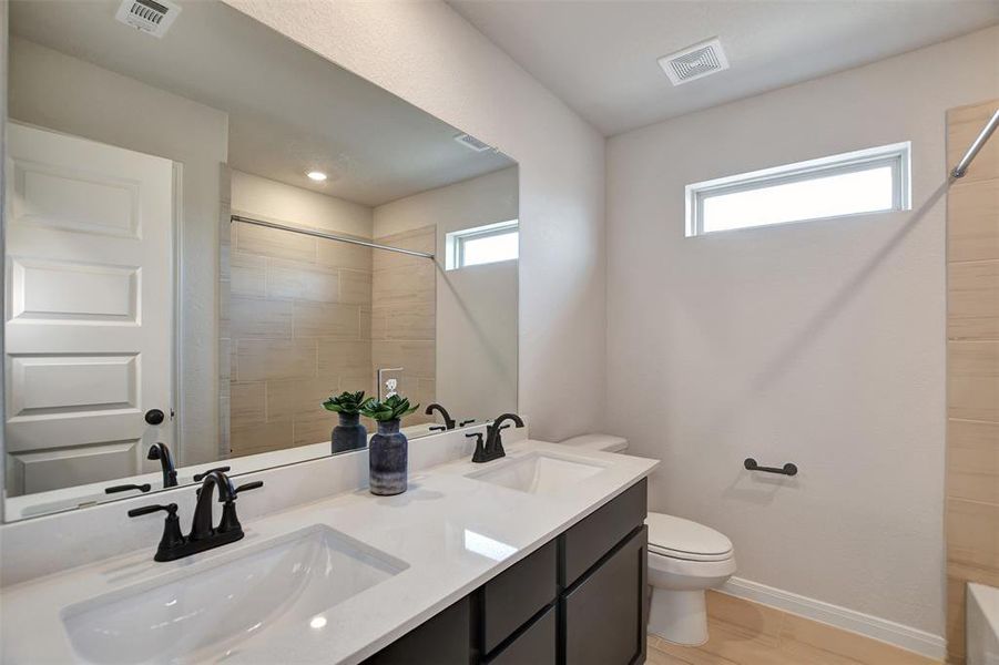 Double sinks in the guest bathroom upstairs