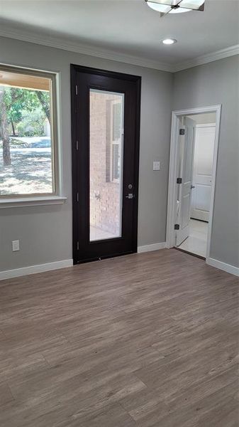 Empty room with crown molding and hardwood / wood-style floors