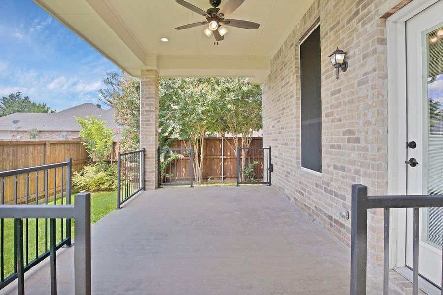 Covered back patio terrace that provides a serene retreat for outdoor living and entertaining!