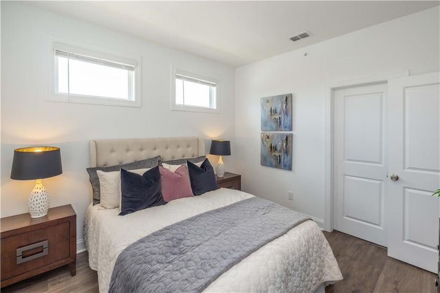 Bedroom featuring dark hardwood / wood-style flooring not the actual unit