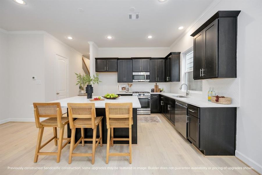 Comfort meets chic: Dive into this spacious kitchen's inviting island that’s perfect for brunch, buffets, and big laughs with loved ones.