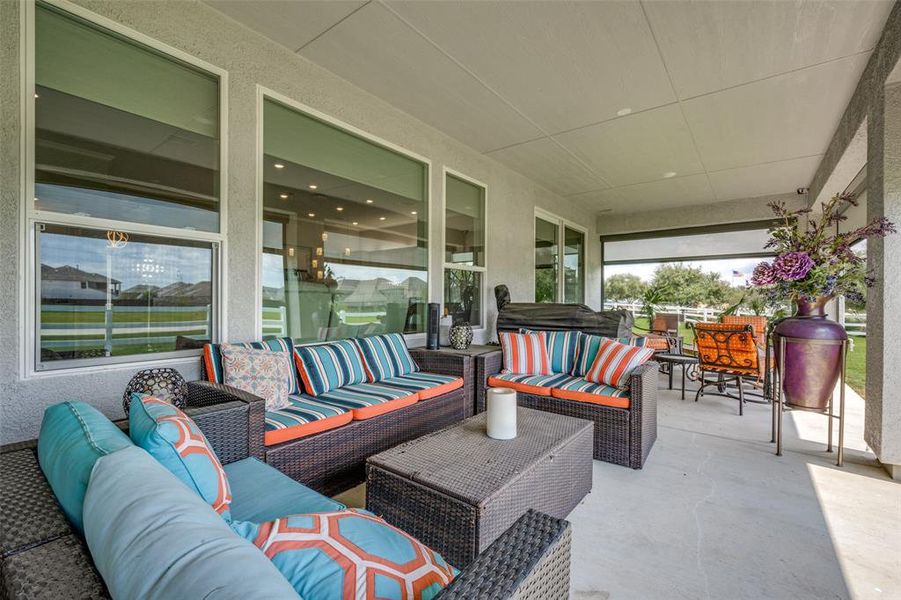 View of patio with outdoor lounge area and screens