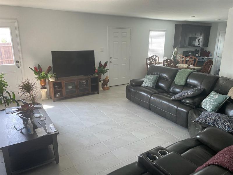 Tiled living room featuring a wealth of natural light