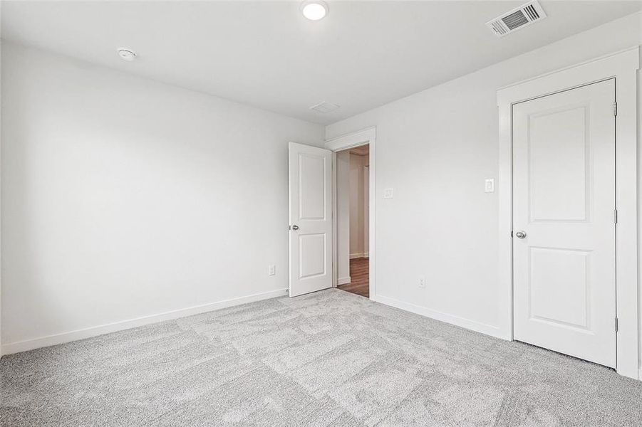 Unfurnished bedroom featuring light carpet