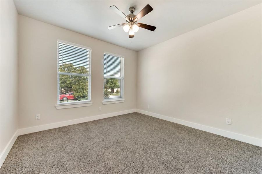 Unfurnished room with ceiling fan and carpet