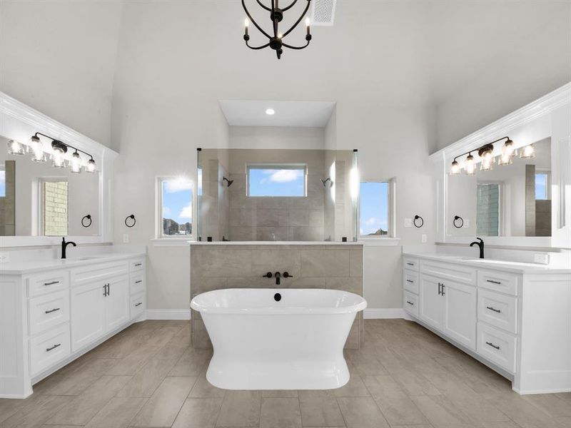 Bathroom featuring oversized vanity, dual sinks, and tile floors