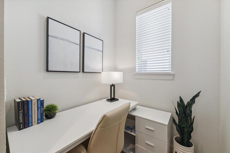 This cozy second-floor study provides a perfect space for a home office or reading nook. Featuring ample natural light from the window, it offers a quiet and private setting for productivity or relaxation. The neutral walls and bright atmosphere create a versatile space that can be customized to suit your needs.