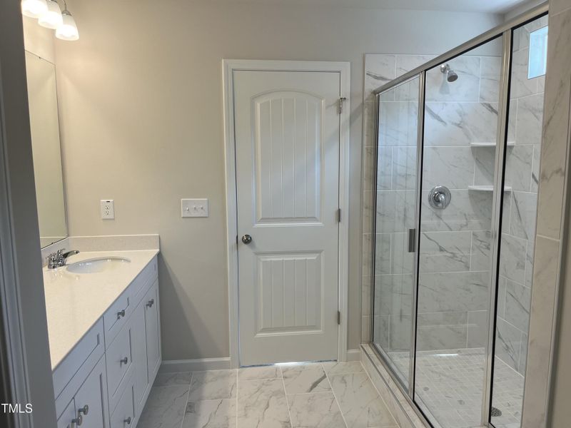 owner's bath with tile flooring