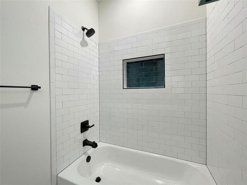 Bathroom featuring tiled shower / bath