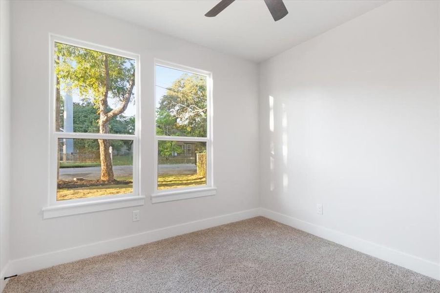 Empty room with carpet flooring and ceiling fan