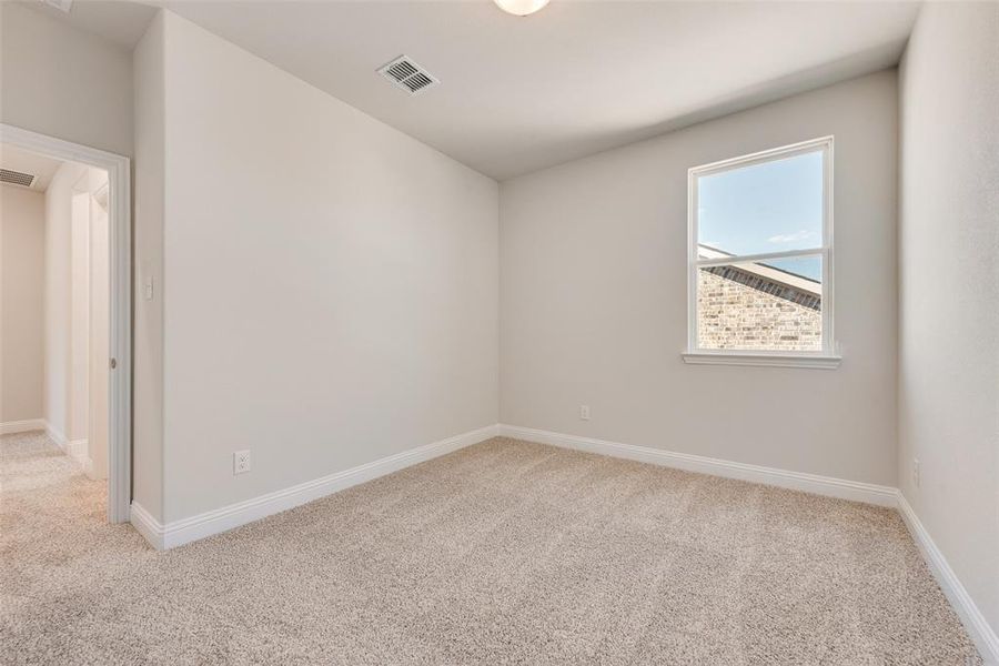 Spare room featuring light colored carpet