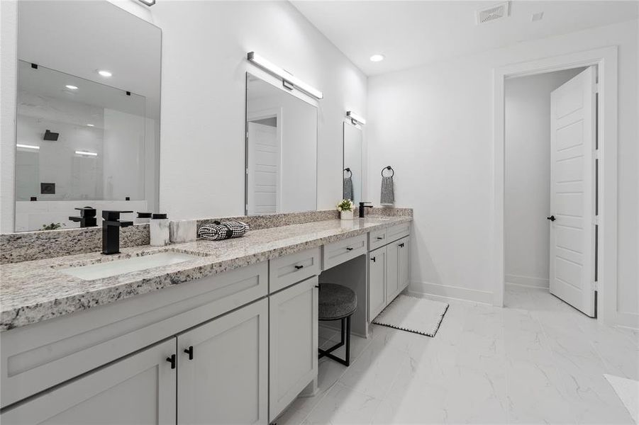 Experience the elegance of this primary bathroom, showcasing a spacious vanity with dual sinks