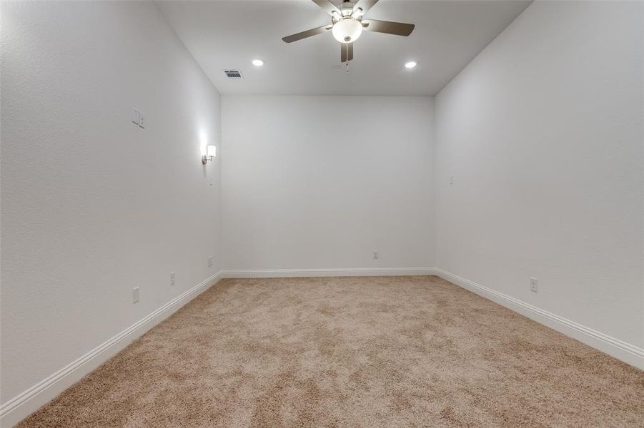 Media room with carpet flooring and ceiling fan