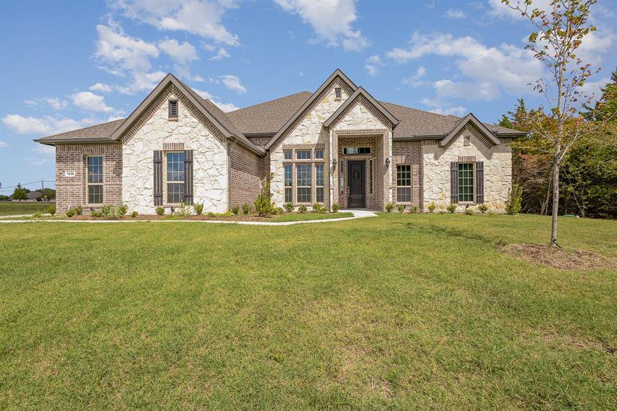 View of front of property with a front yard