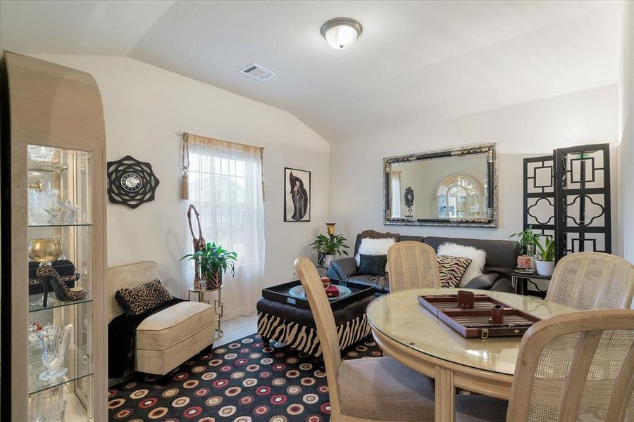 Living room with tile floors and arched ceiling.