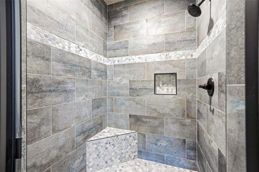 Primary Bathroom featuring a tile shower