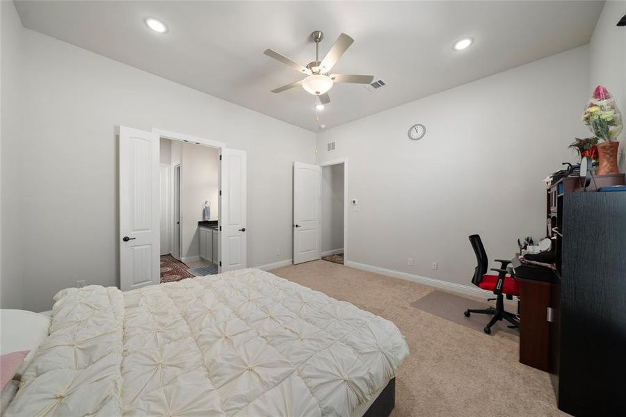 Carpeted bedroom featuring ceiling fan