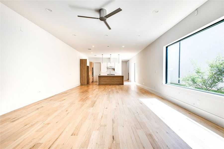 Unfurnished living room featuring light hardwood / wood-style flooring and ceiling fan