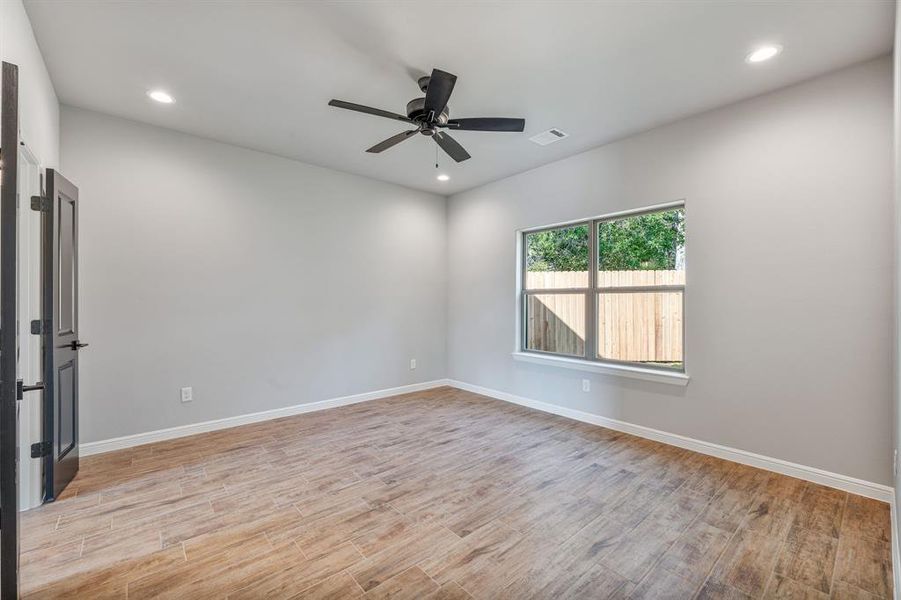 Spare room with ceiling fan and light wood-type flooring