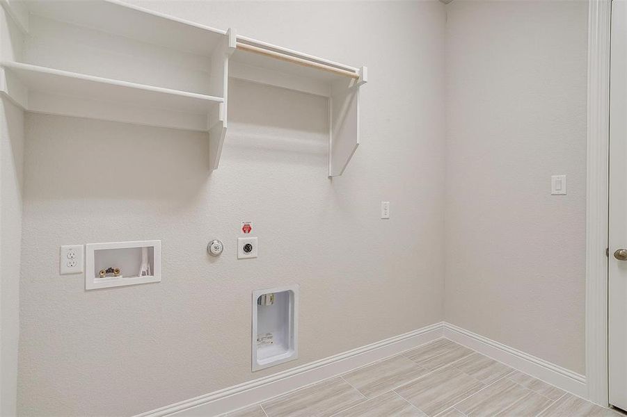 Laundry area featuring hookup for a washing machine, electric dryer hookup, and gas dryer hookup