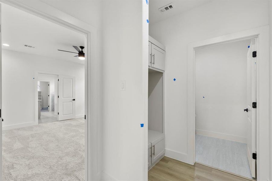 Mudroom with ceiling fan and light hardwood / wood-style floors